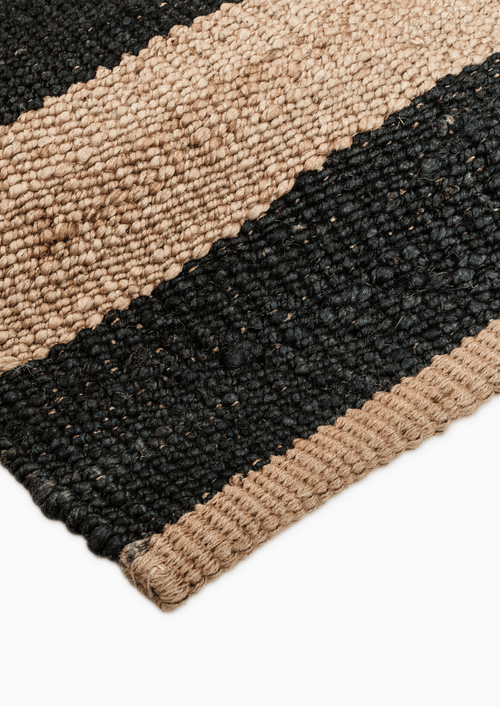 Eco-friendly hemp rug with bold linear black design – handcrafted by artisans.

